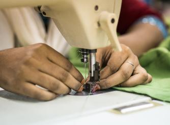 Woman sewing at a garment factory in Bangladesh